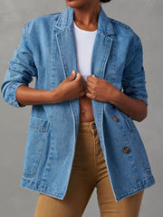 Denim blazer in dusty blue with structured shoulders, buttoned front, and flap pockets.