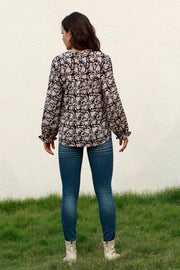 Black floral print blouse with ruffle cuffs and long sleeves