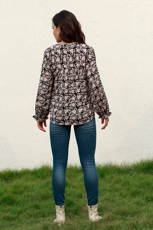 Black floral print blouse with ruffle cuffs and long sleeves