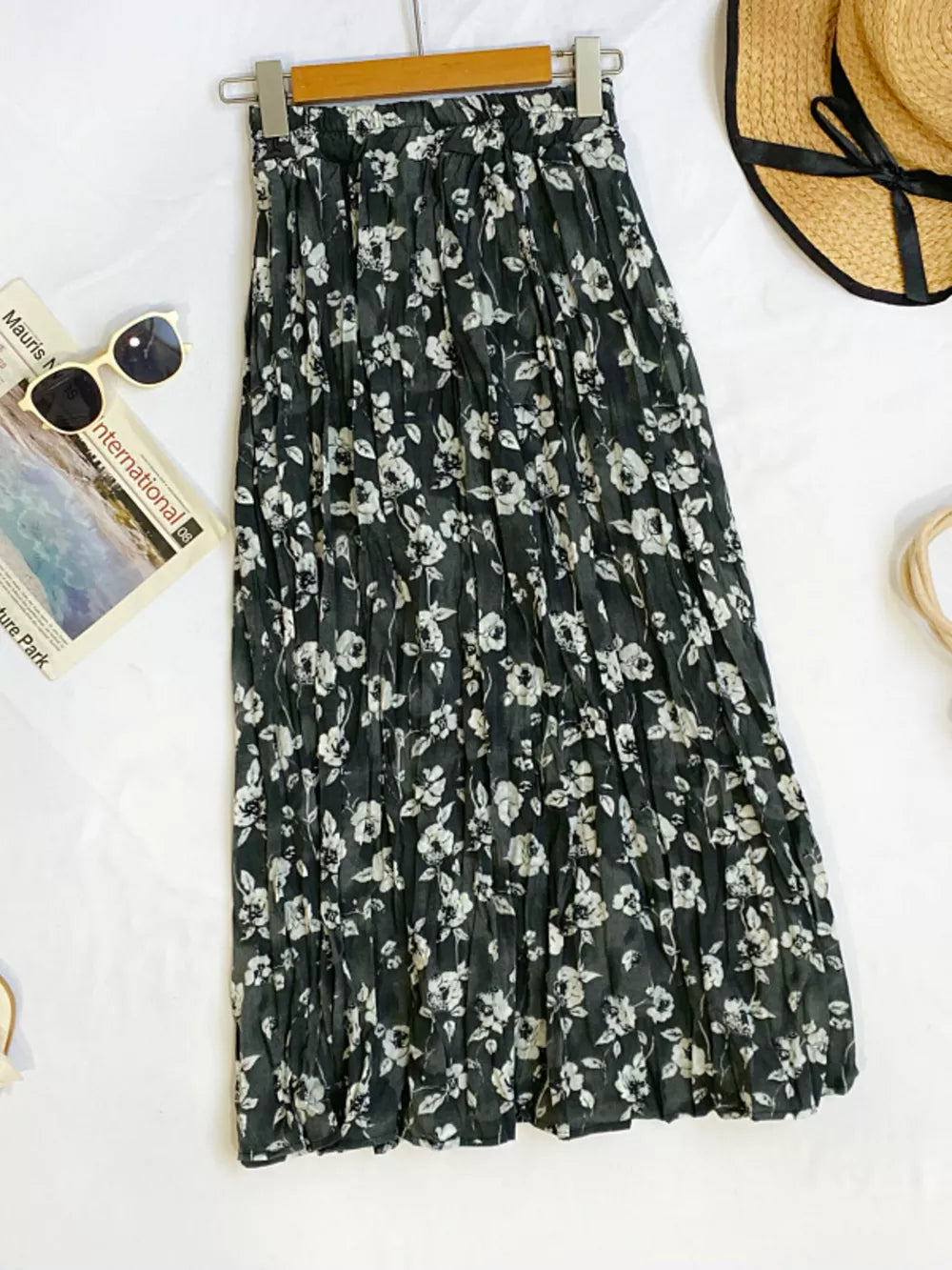 Black botanical pleated midi skirt with crinkled texture and floral print