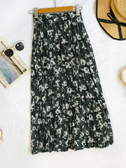 Black botanical pleated midi skirt with crinkled texture and floral print