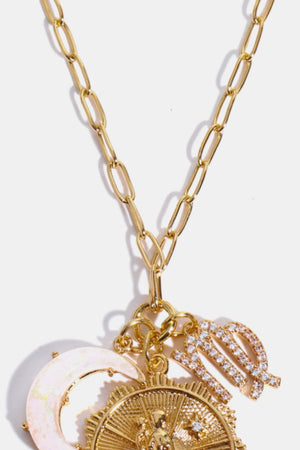 Gold celestial pendant necklace with zodiac symbols and moon charm.