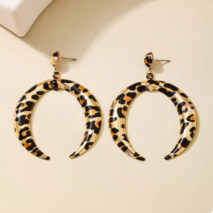 Gold crescent dangle earrings with leopard print pattern