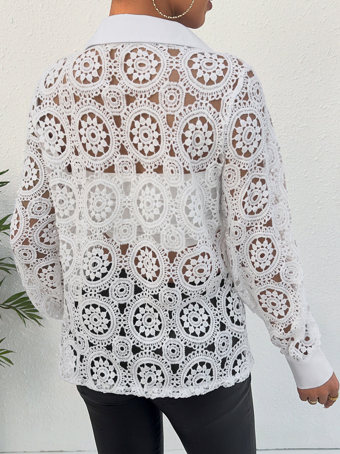 White lace cutout button-up shirt with classic collar and long sleeves.