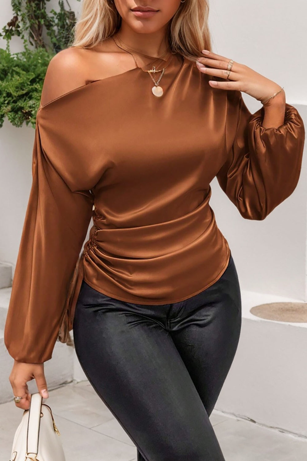 Brown satin blouse with asymmetric neckline, ruched side detail, and balloon sleeves.
