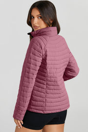 Quilted stand collar puffer jacket in a dusty rose color with horizontal quilting detail.