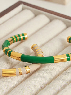 Striped enamel and gold bangle bracelet in dark green with gold accents.