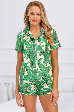 Green botanical print satin pajama set with button-up shirt and shorts.