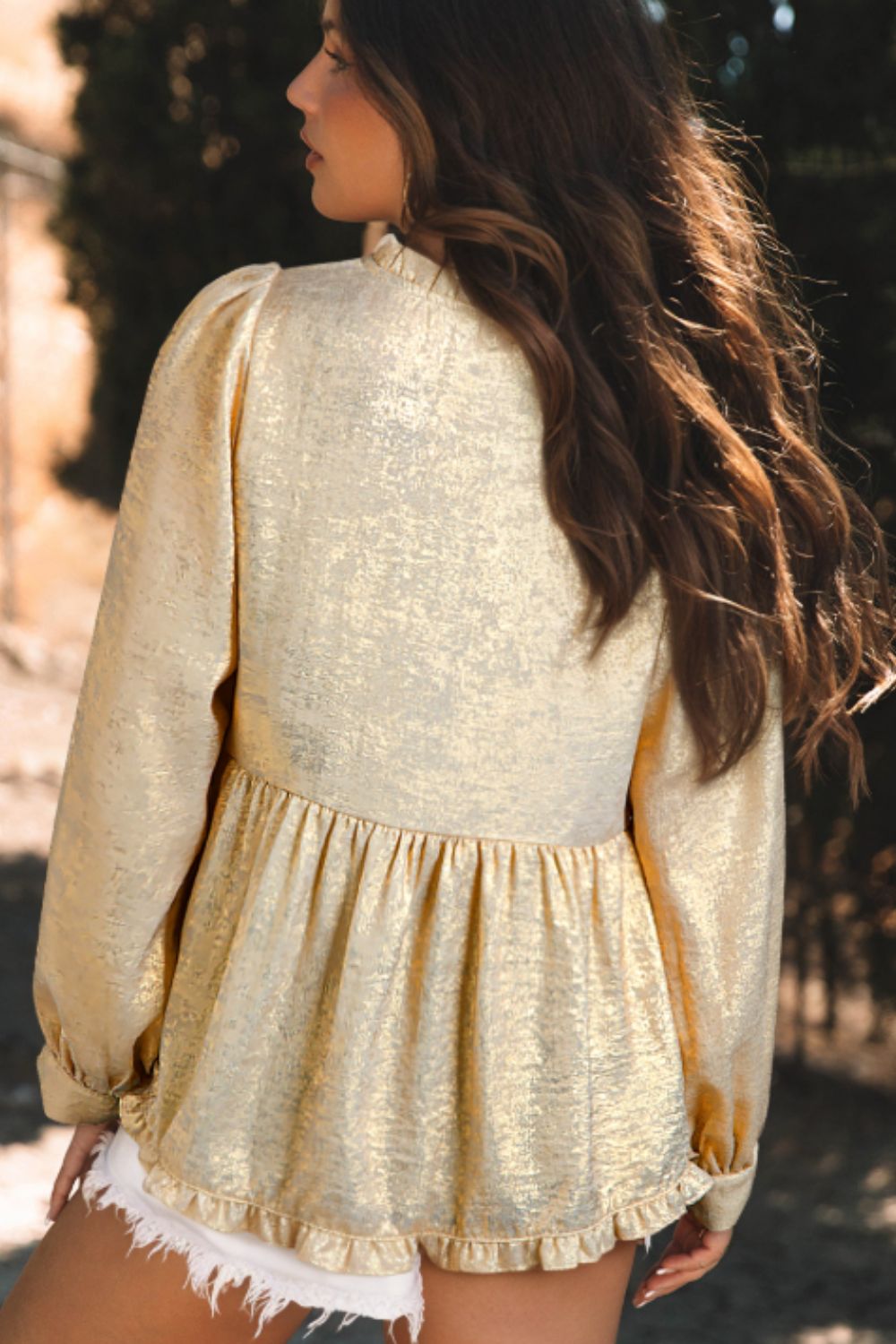 Metallic gold blouse with gathered sleeves and tiered ruffle hem, shown from back.