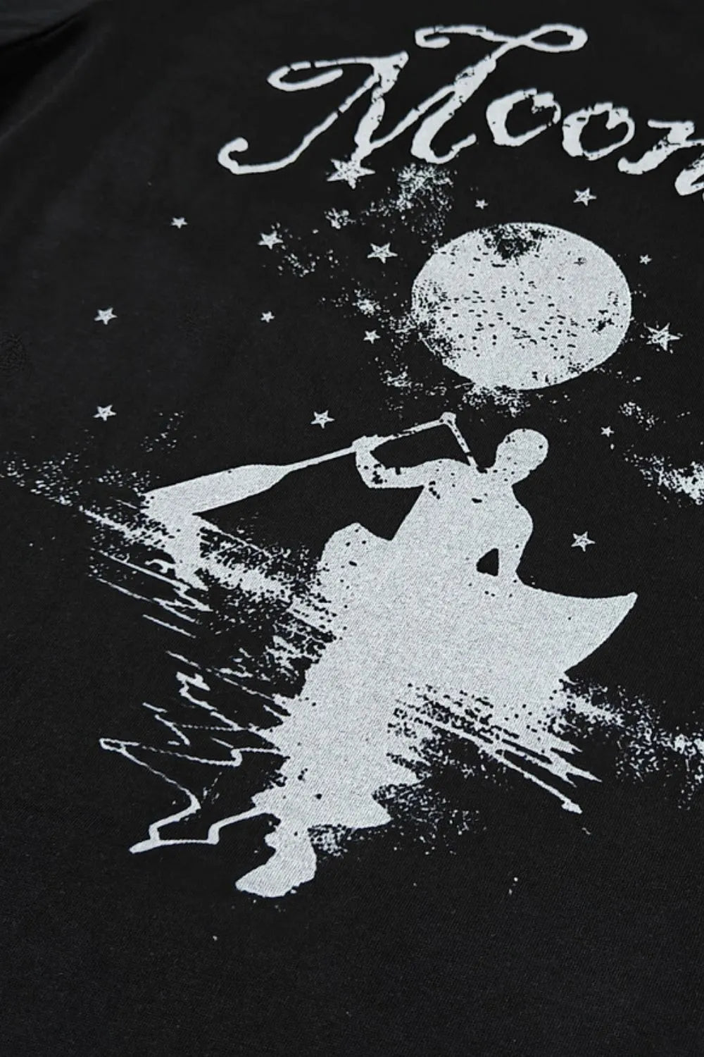 Black oversized tee with white graphic of a person kayaking under a moon and stars.