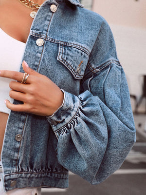 Medium wash denim cropped jacket with balloon sleeves and buttoned front.