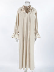 Beige cotton maxi dress with tie neck and ruffled cuffs