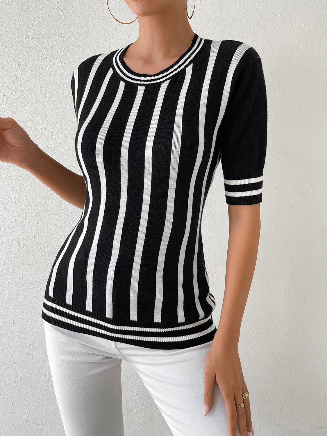 Black and white striped knit tee with trim detail and short sleeves.