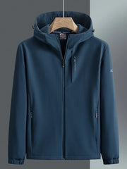 Men's hooded windbreaker in Peacock Blue with zippered pockets and subtle sleeve logo.