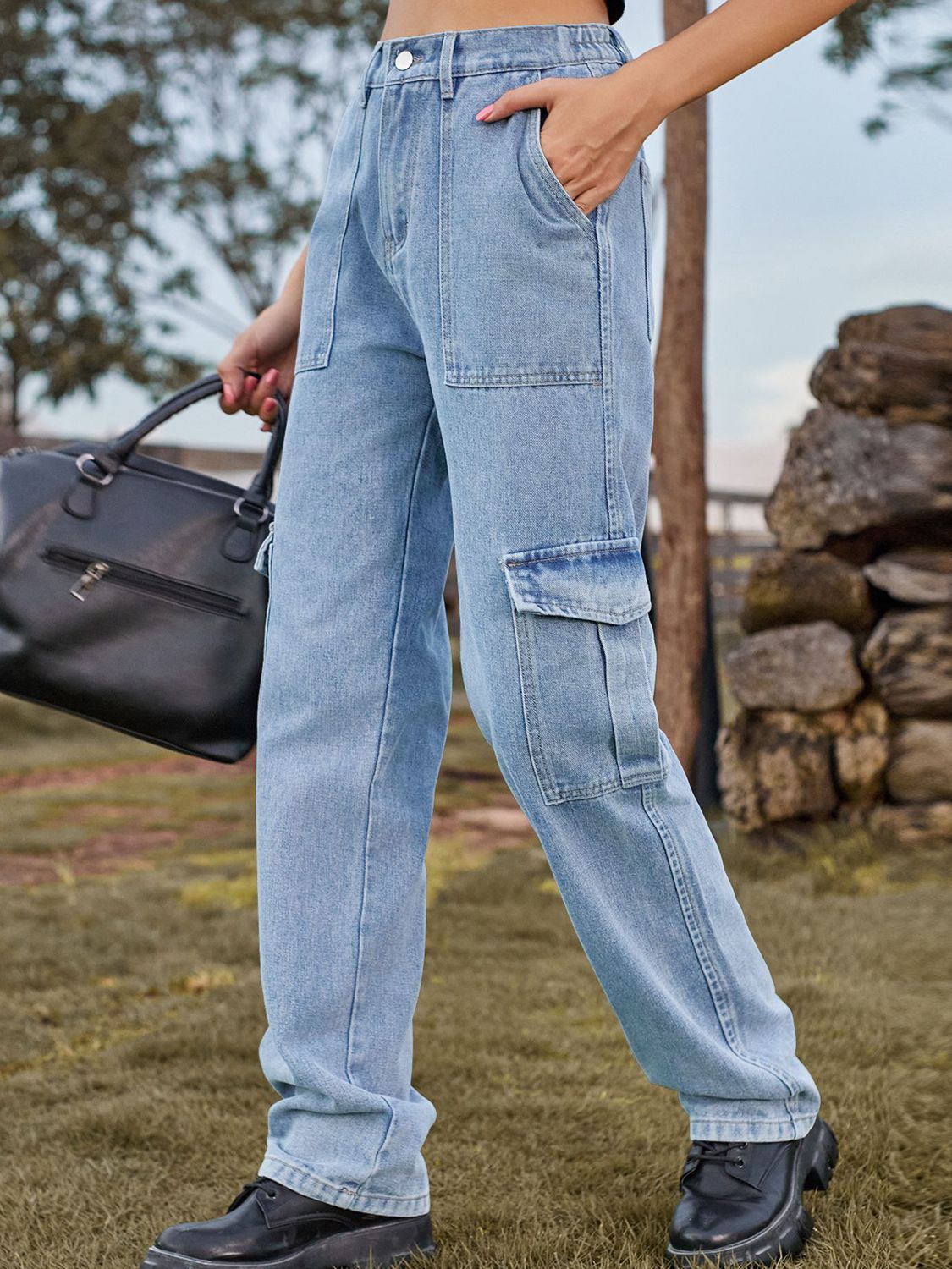 Light wash denim straight leg cargo pants with utility pockets and a relaxed fit.