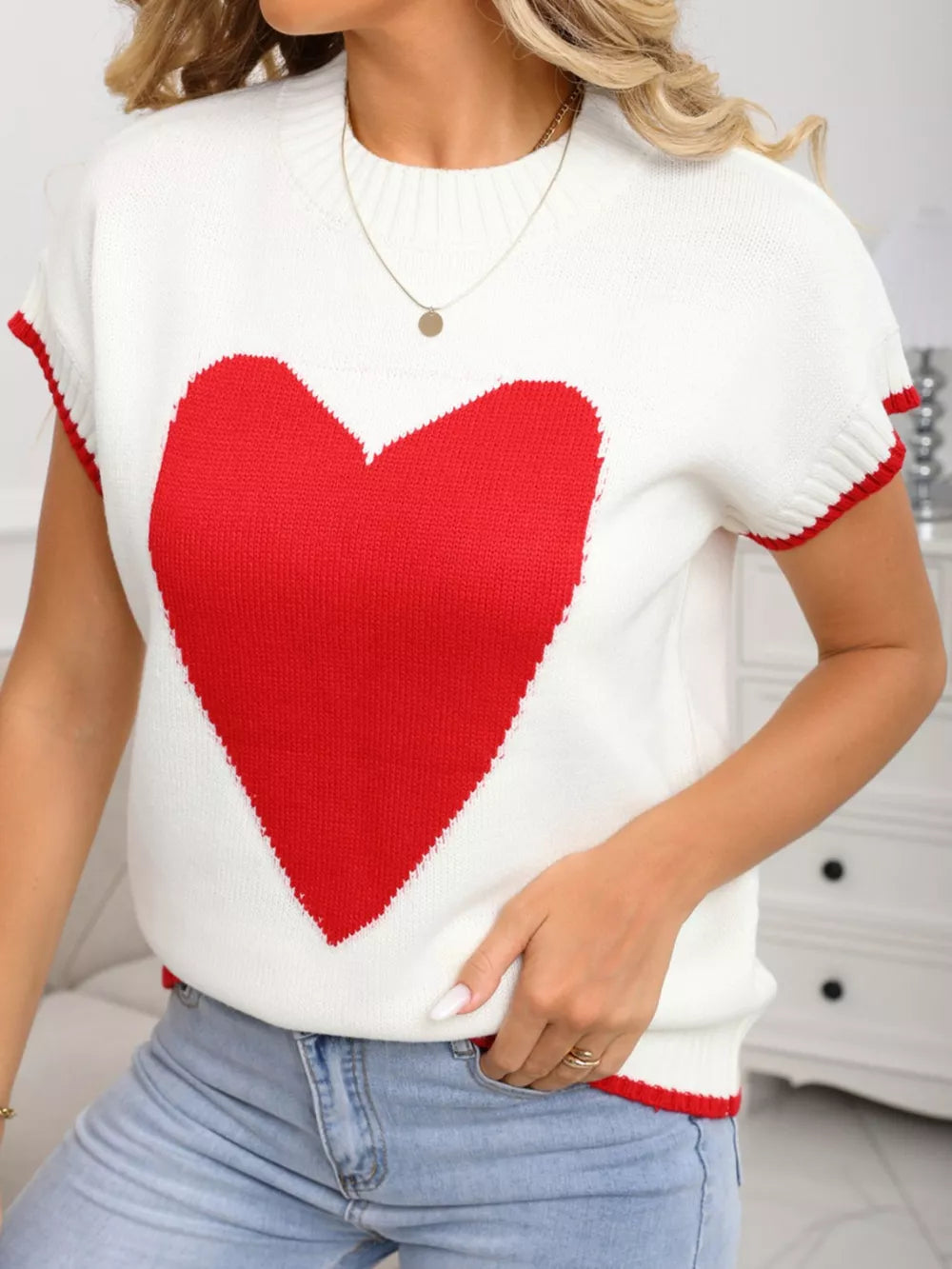 White acrylic knit sweater vest with large red heart graphic and ribbed accents
