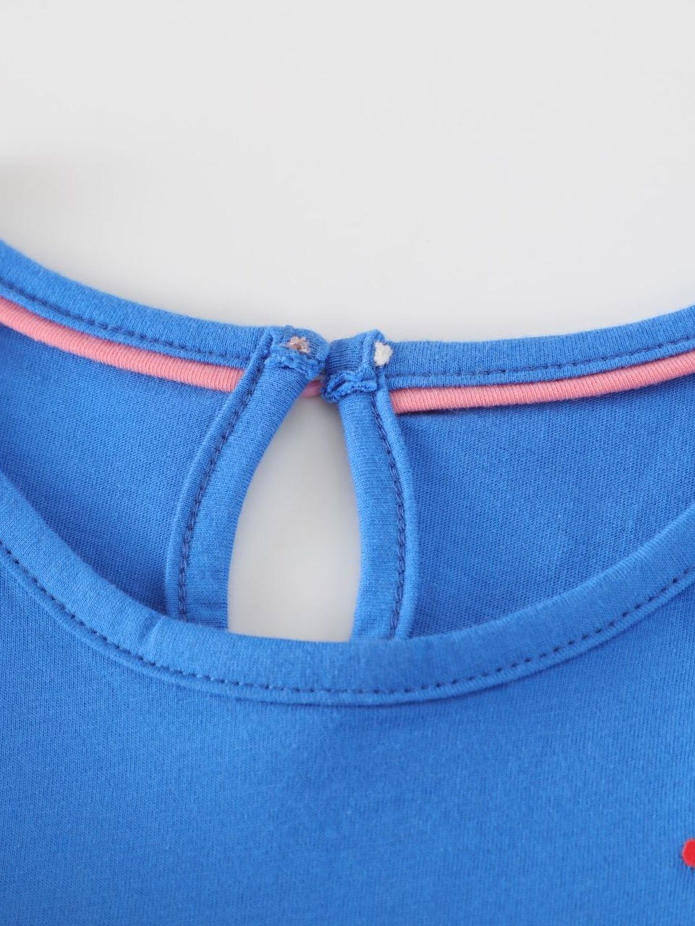 Blue cotton baby dress with keyhole back and pink trim