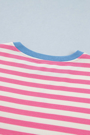 Short sleeve tee with pink and white stripes and a blue crew neck.
