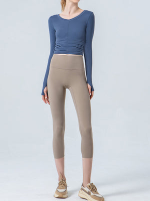 Beige capri leggings with a high waistband and a subtle seam detail.