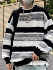 Relaxed fit black and white striped sweater with textured details and crew neck.