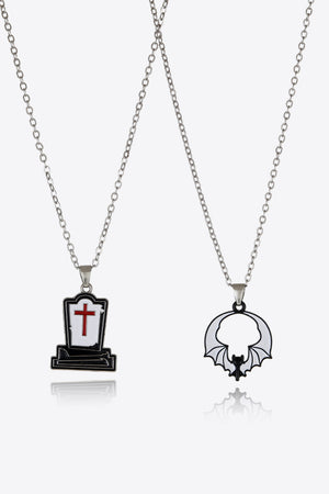 Spooky season necklaces with tombstone and bat enamel pendants on silver chains.