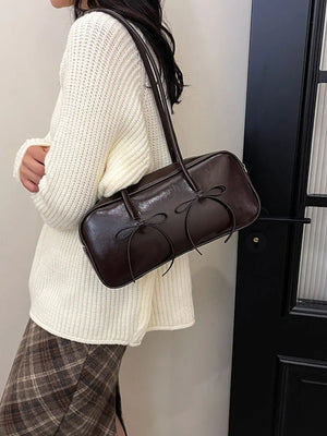Brown patent leather shoulder bag with bow detail