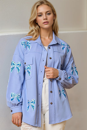 Light blue oversized shacket with embroidered sequin bow details and frayed hem.
