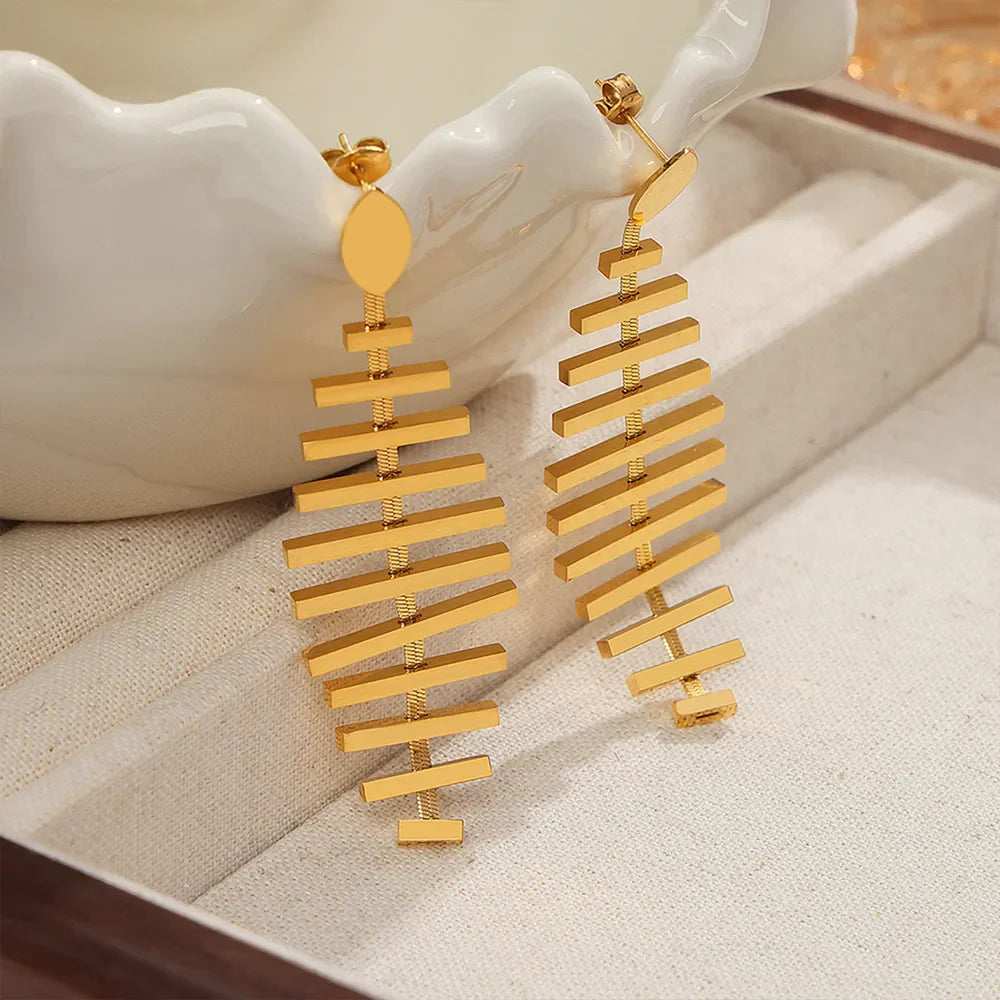 Gold steel fishbone drop earrings with geometric design