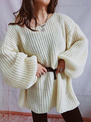 Cream oversized ribbed knit sweater with balloon sleeves and a belted waist.