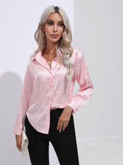 Blush pink satin button-down shirt with embossed leopard print and collared neckline.