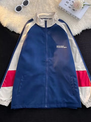 Men's blue zip-up track jacket with white and red colorblock sleeves and white collar.