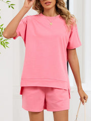 Pink relaxed two-piece set with crew neck t-shirt and shorts, featuring pockets.