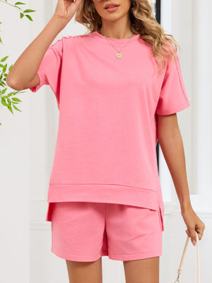 Pink relaxed two-piece set with crew neck t-shirt and shorts, featuring pockets.