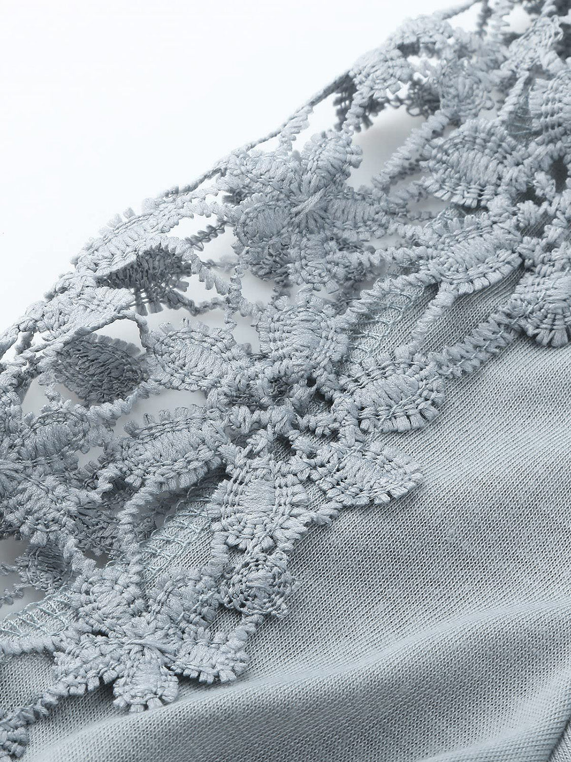 Light gray blouse with intricate lace yoke and sleeve details.