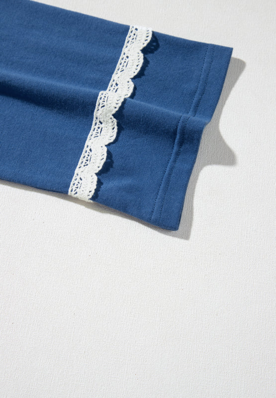Dusty blue bell sleeve blouse with white lace trim detail on the sleeve cuff.