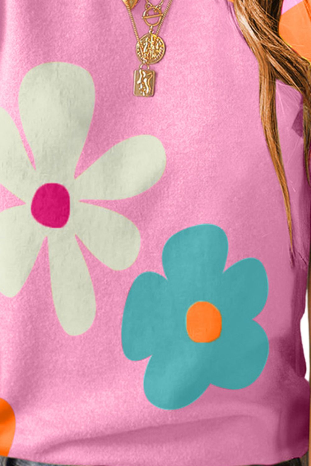 Pink puff sleeve top with large white and aqua floral print.