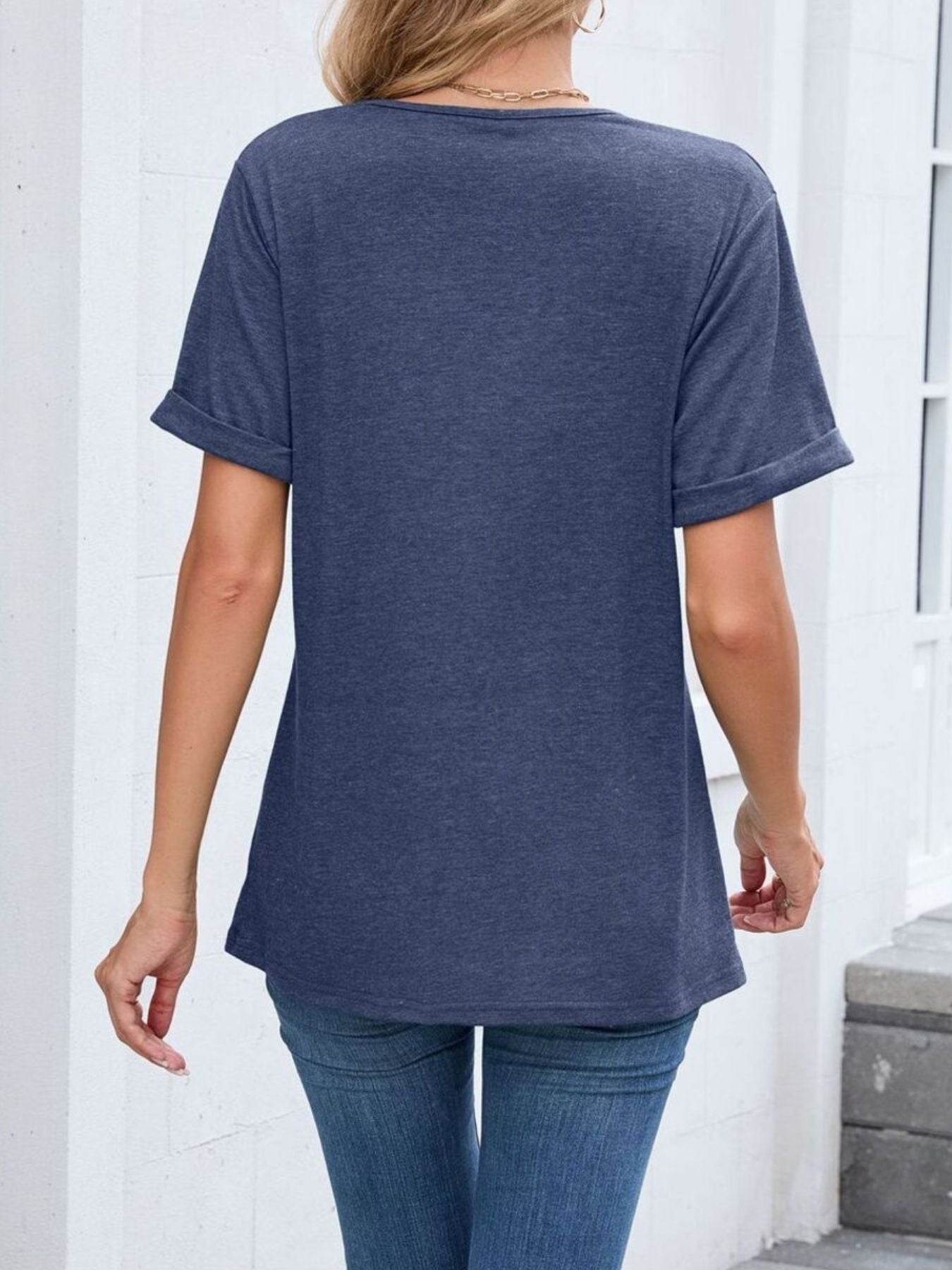 Navy blue v-neck t-shirt with cuffed short sleeves and a relaxed fit.