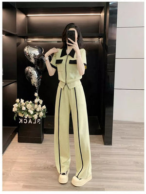 Beige zip-up top and wide-leg pants set with black trim and collar.