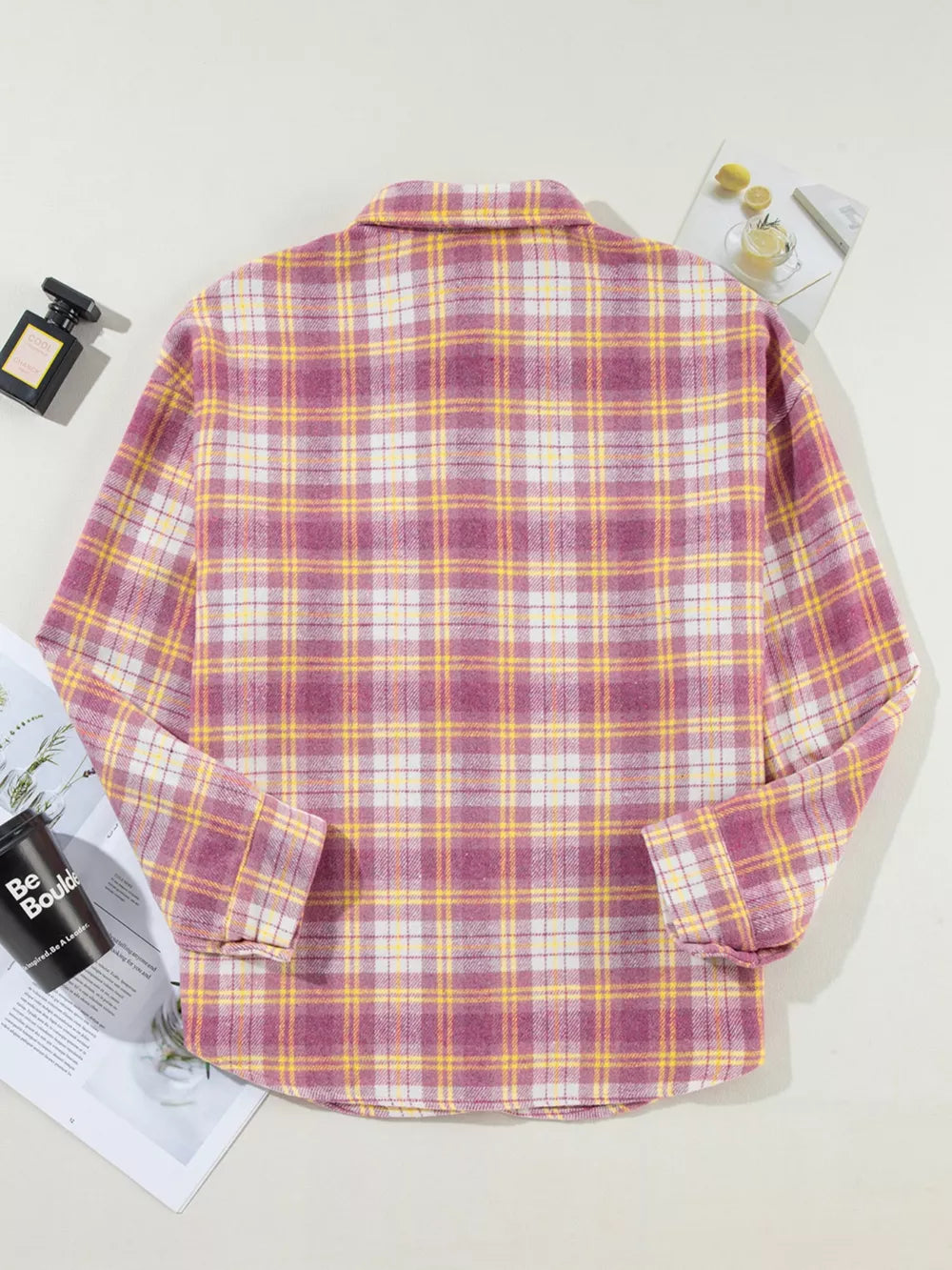 Oversized plaid shacket with classic collar and curved hem in pink, yellow, and white plaid.