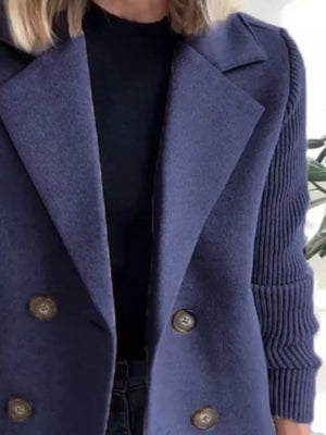 Dark blue double-breasted trench coat with knit sleeves and button detail