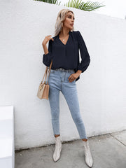 Dark blue Swiss dot sleeve gathered blouse with V-neck and ruffled detail.