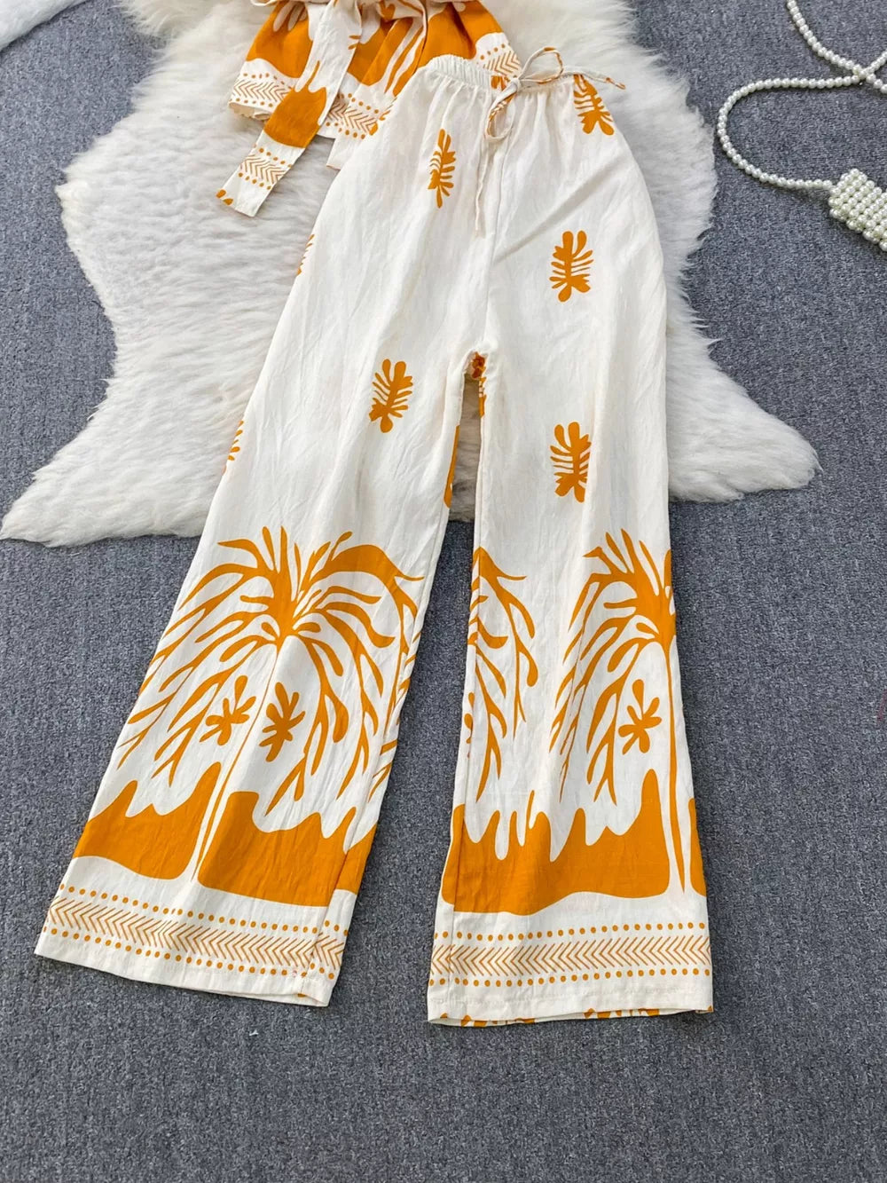 Tropical print wide leg pants with drawstring waist and belted detail, polyester.