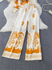 Tropical print wide leg pants with drawstring waist and belted detail, polyester.