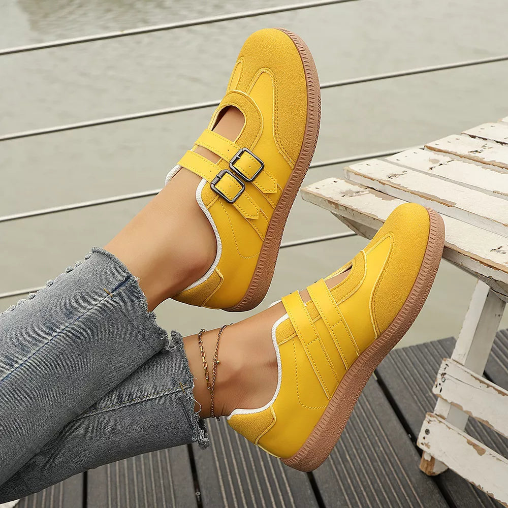 Yellow buckle strap Mary-jane inspired sneakers with suede accents and white trim.
