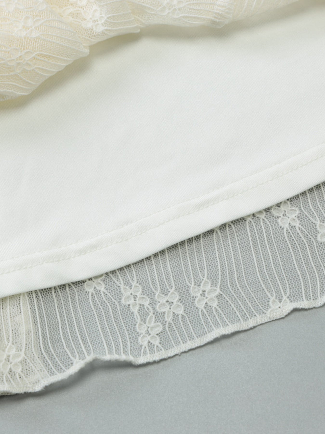 White lace backless mini dress with asymmetrical hem detail