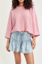Light blue denim ruffle mini skirt with lace-up front and button detail