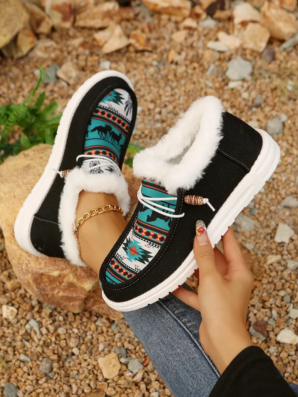Southwestern print faux fur lined loafers in black with white trim and white soles.