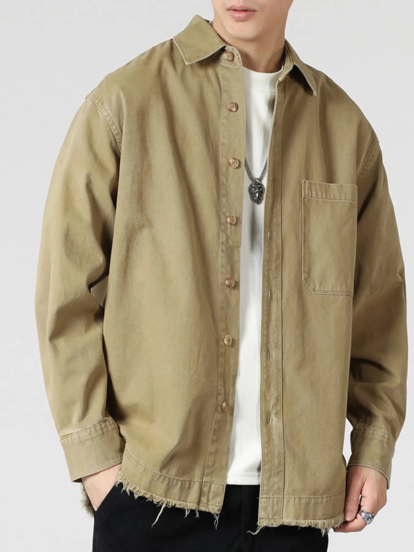 Oversized khaki button-up long-sleeve overshirt with frayed hem and chest pocket.