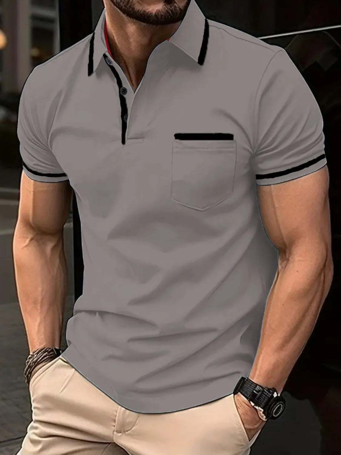 Gray short sleeve polo with black contrast trim on collar, pocket, and sleeves.