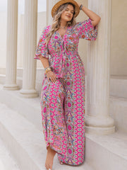Bohemian tie-front palazzo jumpsuit in deep rose with bell sleeves and a vibrant paisley print.